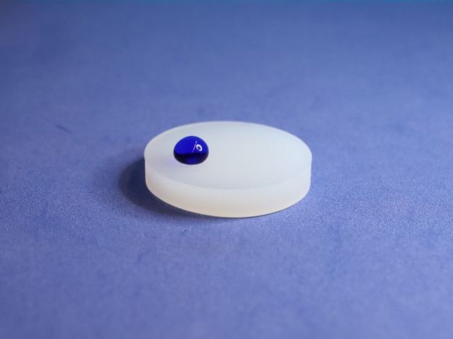 Plastic disc with blue drop